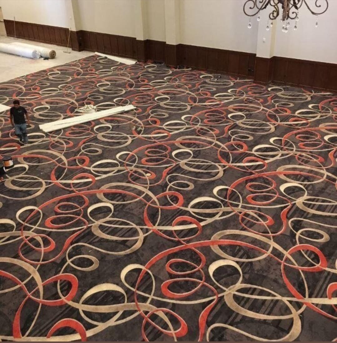 Modern abstract carpet design installation in Vadodara – hand-tufted custom rug for conference rooms and event halls.