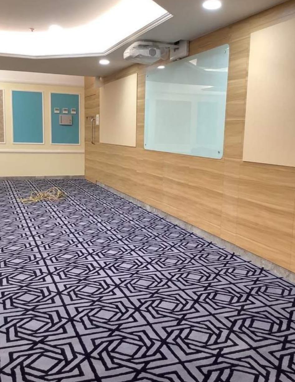 Prayer hall carpet installation in Udaipur – elegant mosque runner design with geometric pattern.