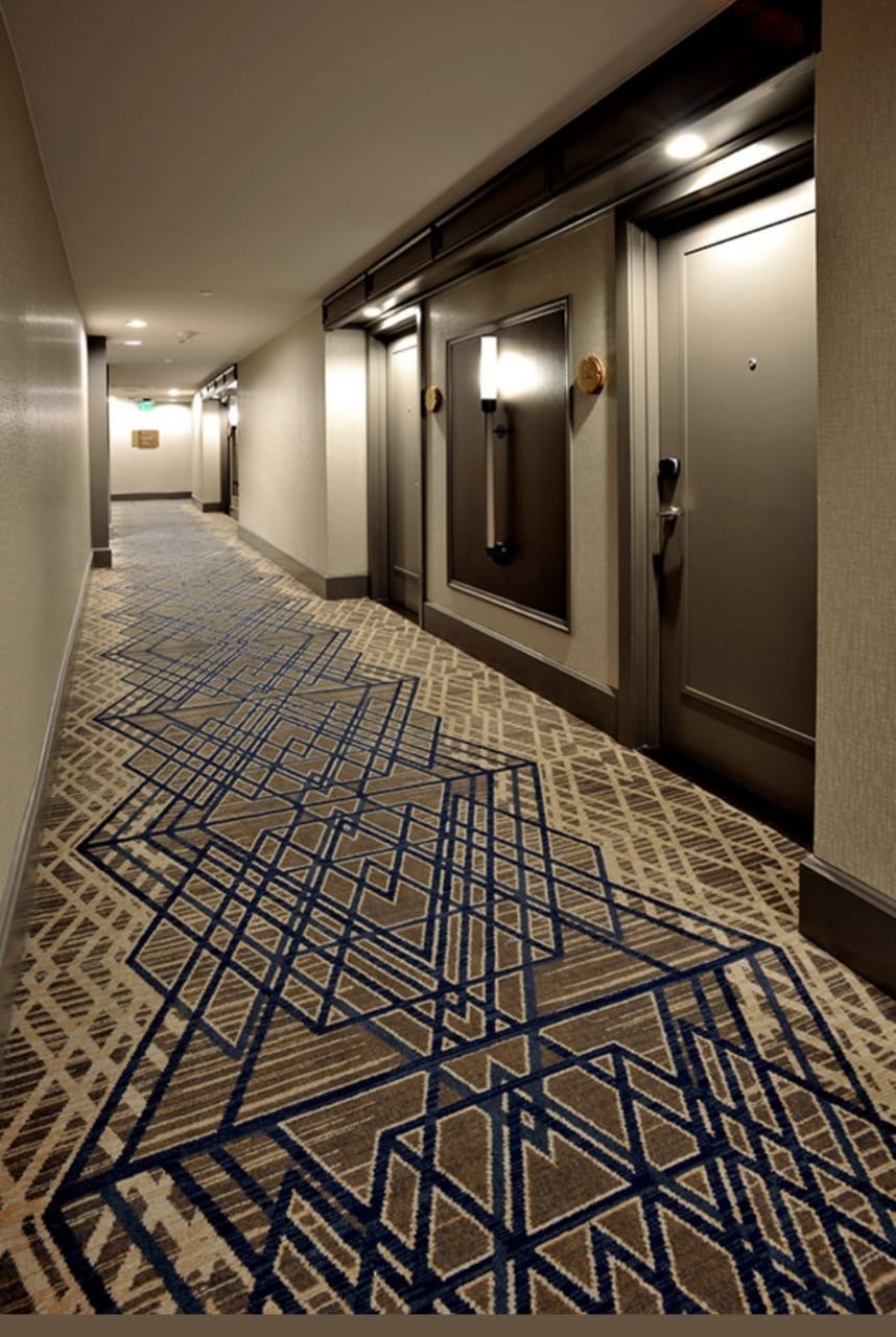 Hotel corridor geometric carpet installation in Vadodara – custom hallway rug design for premium hospitality interiors.