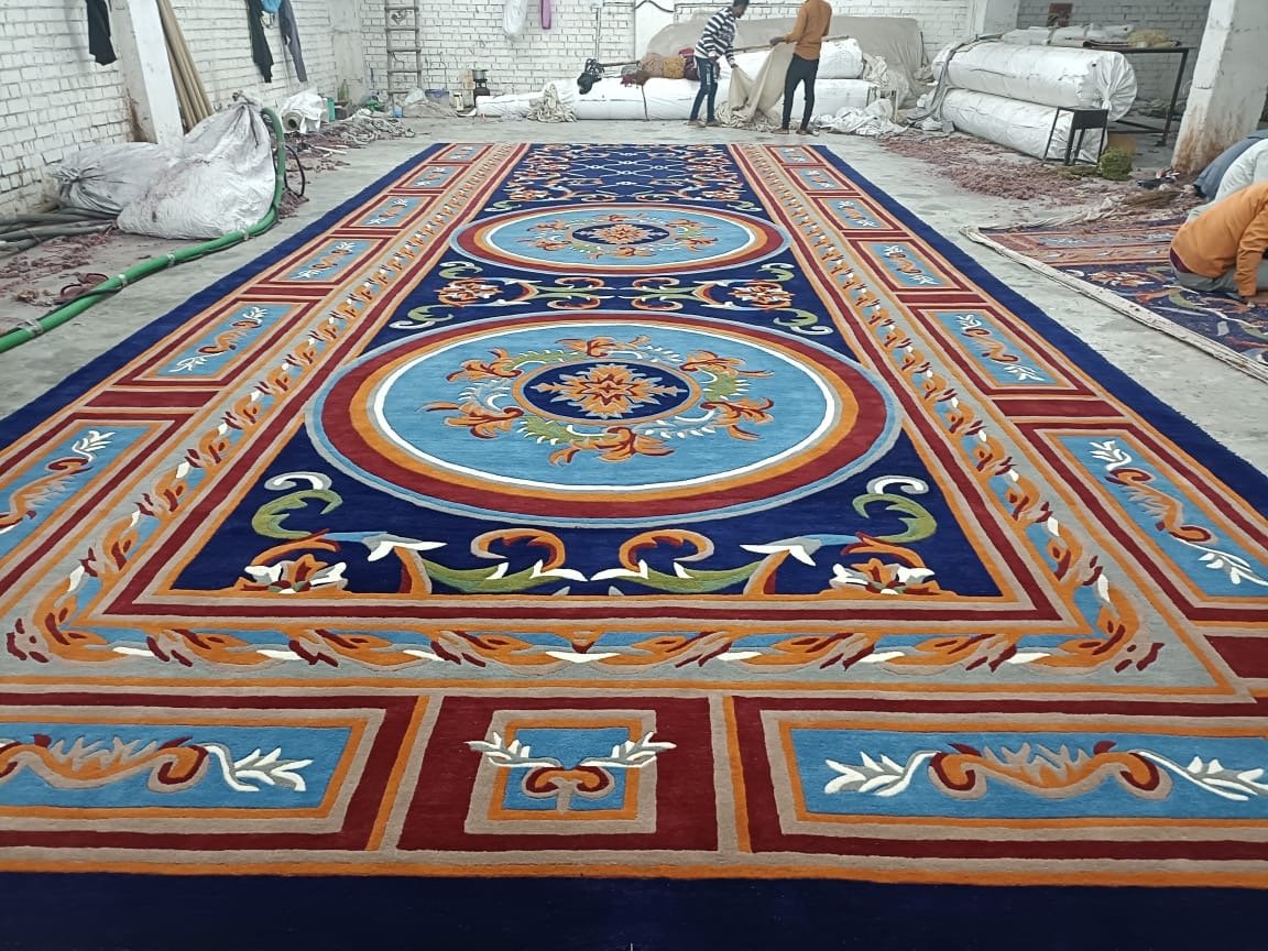 Royal design handmade carpet production for hotels in Udaipur – detailed hand-tufting of premium custom rug.